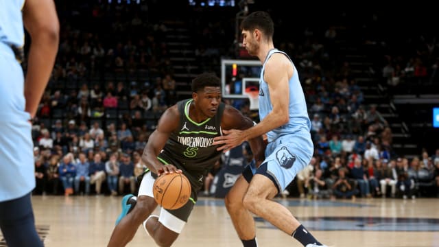 Nov 26, 2023; Memphis, Tennessee, USA; Minnesota Timberwolves guard Anthony Edwards (5) dribbles as Memphis Grizzlies forward Santi Aldama (7) defends during the first half at FedExForum.